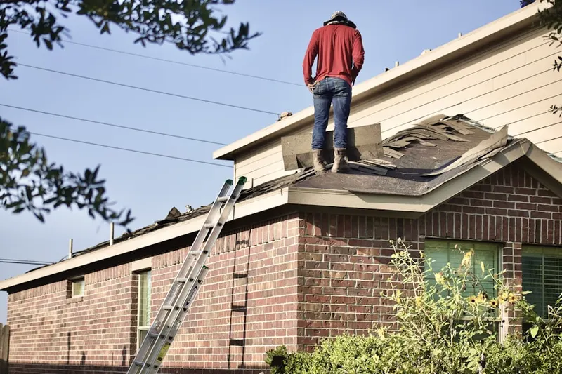 Professional roofer working on a residential roof in Chadwyck